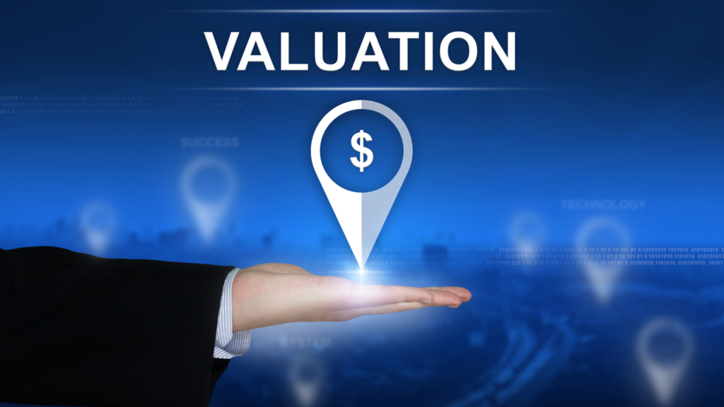 Hand holding a dollar location icon under the word “Valuation” symbolizing business worth and financial assessment.